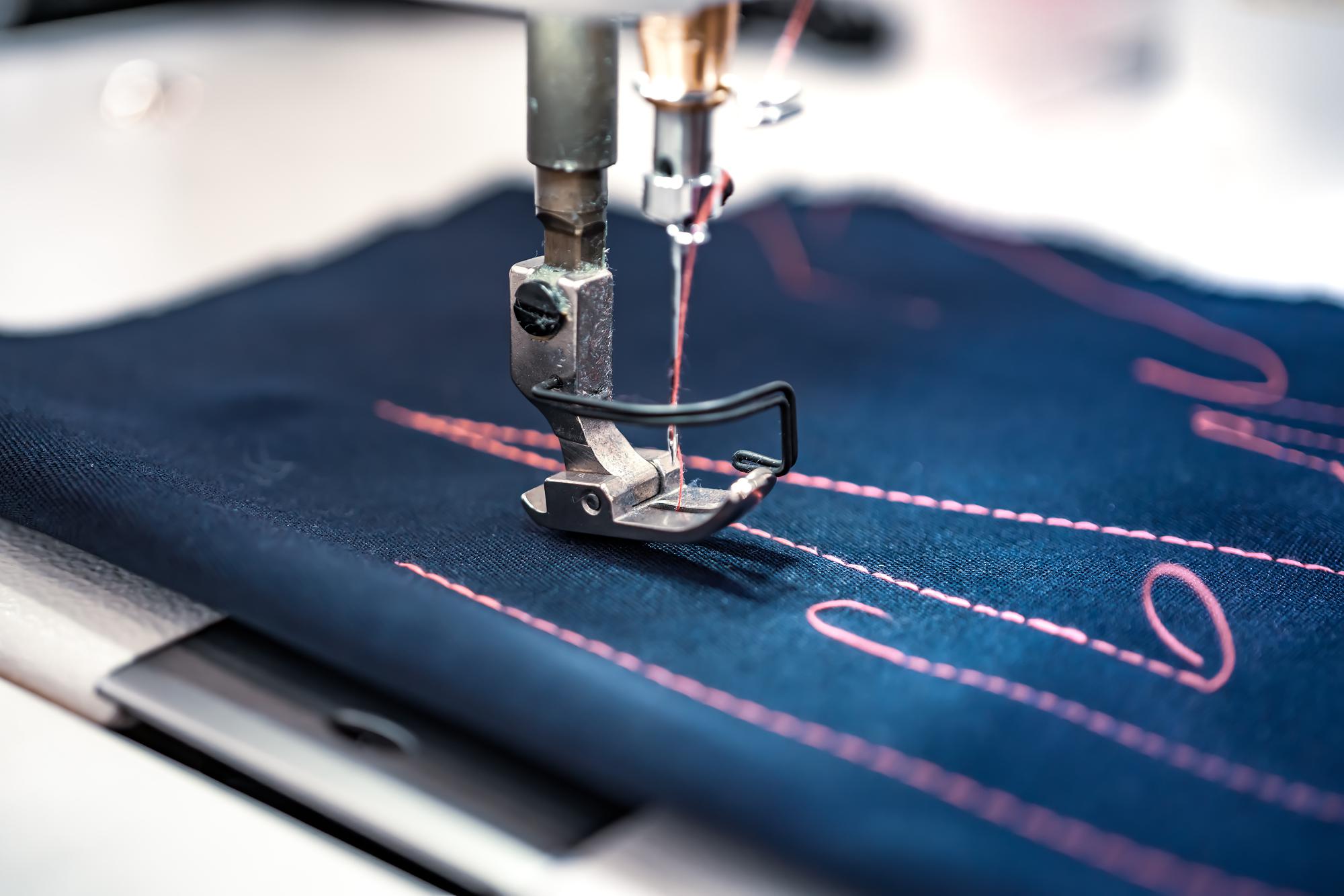 modern embroidery machine stitching a logo on denim